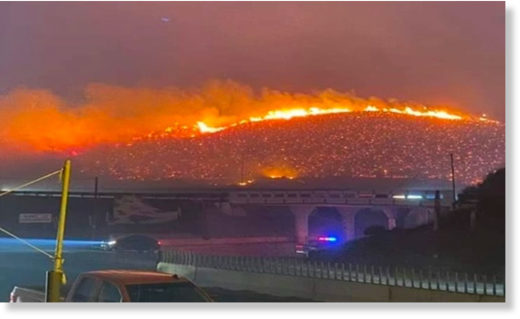 A wildfire burns yesterday in Tijuana