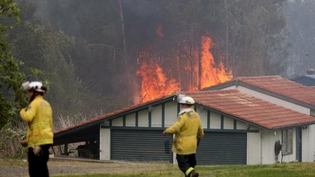 Click to enlarge Firefighters battle an out of control bushfire on the Lakes Way, Darawank, near Forster on the NSW mid north coast.