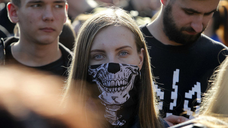 Click to enlarge masked protester
