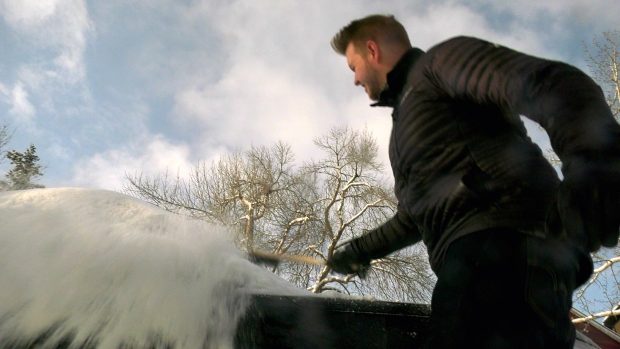 Calgarians clear fresh snowfall from cars and driveways Sunday morning after and estimated 20 centimetres blanketed most of the city.