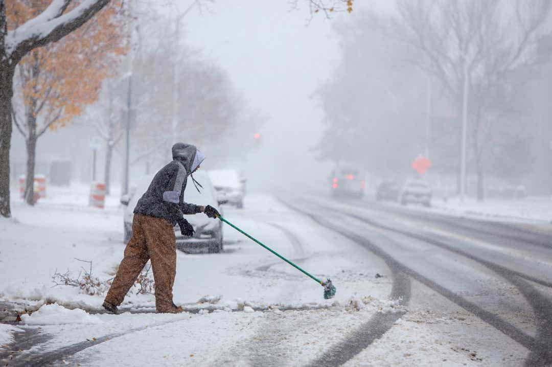 Click to enlarge Steven Holston of Detroit helps out an aging family member by managing their snow on E. Grand Blvd. as snow hit the region Monday, Nov. 11, 2019.