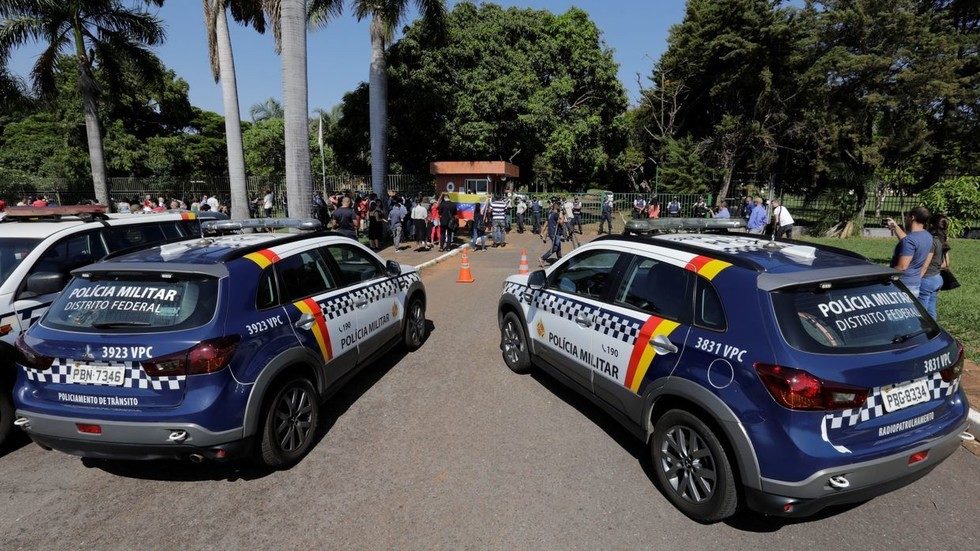 Police cars are seen outside the occupied Venezuelan embassy in Brasilia, Brazil.