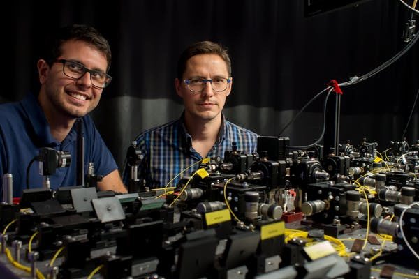 Click to enlarge Researchers with experiment