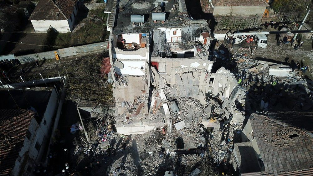 Rescuers search at a damaged building after a magnitude 6.4 earthquake in Thumane, western Albania, Tuesday, Nov. 26, 2019