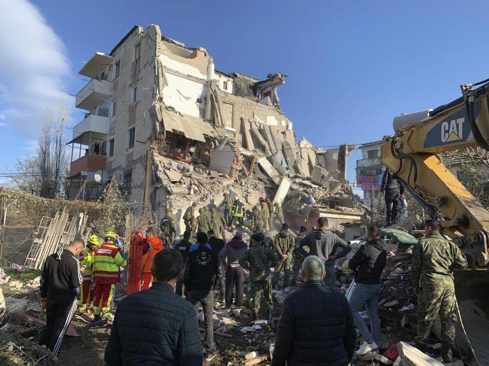 Rescuers search at a damaged building after a magnitude 6.4 earthquake in Thumane, western Albania