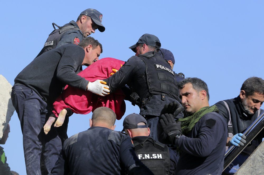 Rescuers hold the body of a five-year old girl after a magnitude 6.4 earthquake in Thumane, western Albania, Tuesday, Nov. 26, 2019