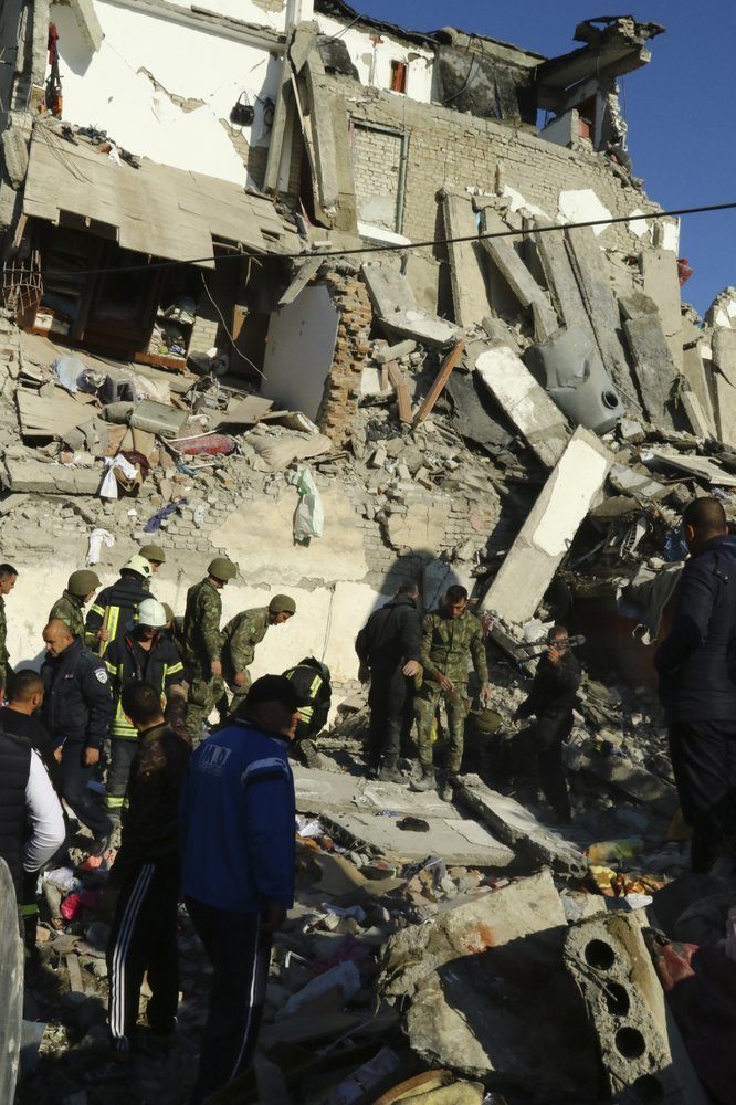 Rescuers search at a damaged building after a magnitude 6.4 earthquake in Thumane, western Albania, Tuesday, Nov. 26, 2019.