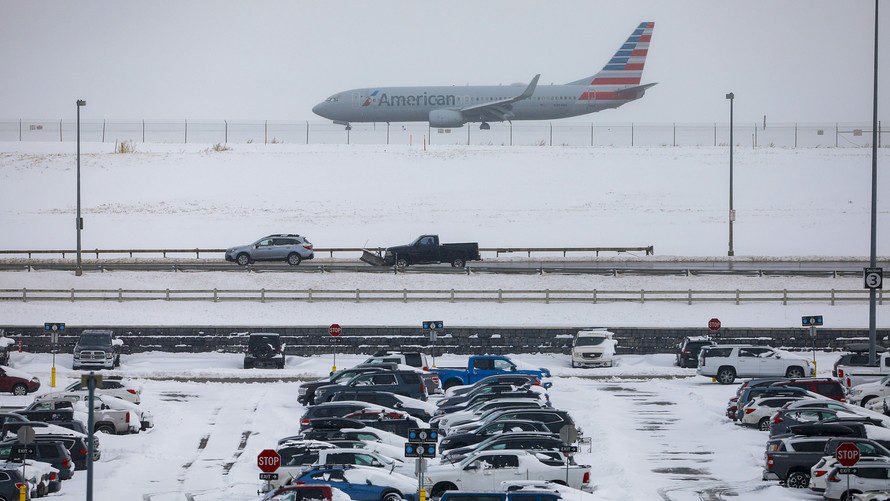 A jet passes snow-covered cars parked at Denver International Airport on November 26, 2019 in Denver, Colorado. Flights were delayed and rescheduled due to a winter storm that dropped nearly a foot of snow in the city.