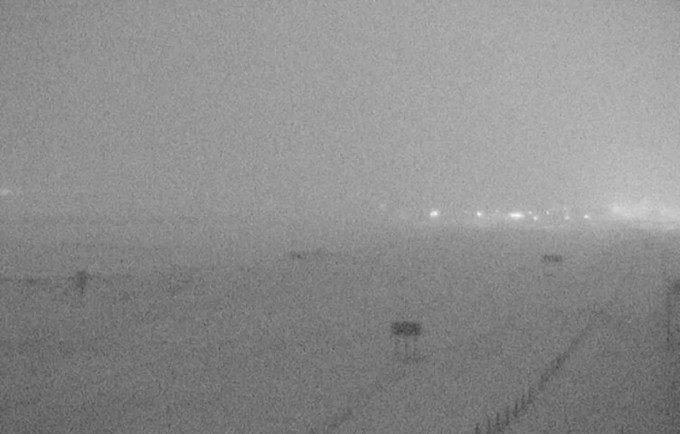 A highway camera in Montana shows near white-out conditions near Sweet Grass, Mont., at 7:50 p.m. Wednesday