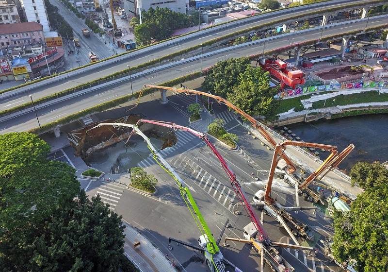 Cranes are deployed in Guangzhou, the capital of Guangdong province, after a road collapsed near a construction site on Sunday morning.