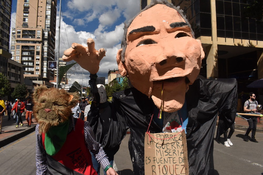 a sculpture of Alvaro Uribe protests