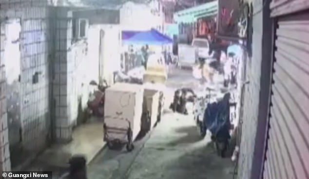 Shocking moment four pedestrians are swallowed by a sinkhole