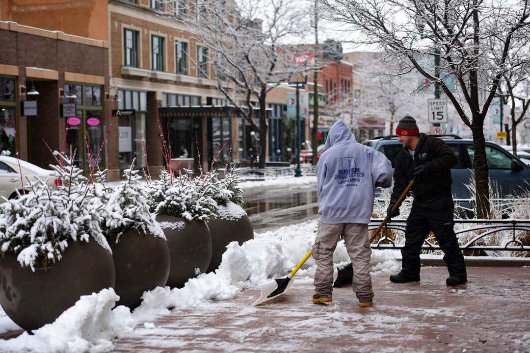 Click to enlarge Landscape workers shovel snow from the walk paths downtown on Dec. 29, 2019, in Sioux Fall