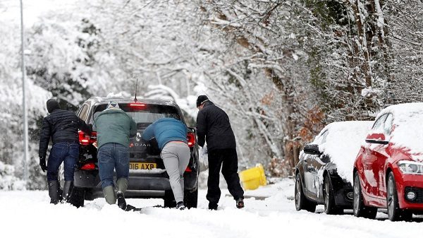 Click to enlarge Men pushing car