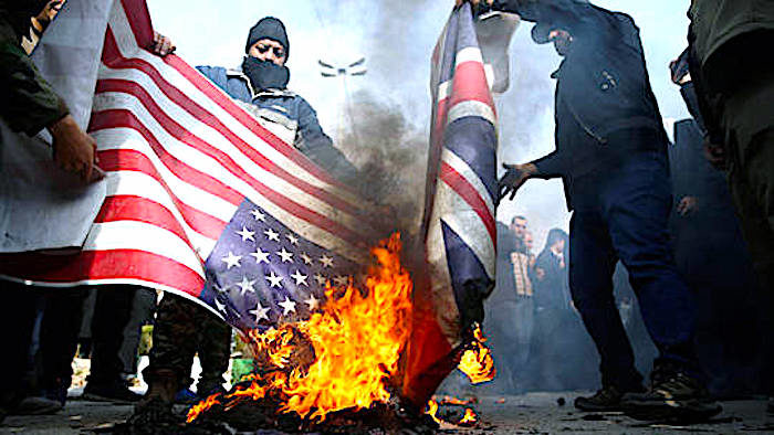 Click to enlarge Demonstrators burn flags