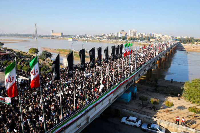 Click to enlarge Iranians cross bridge