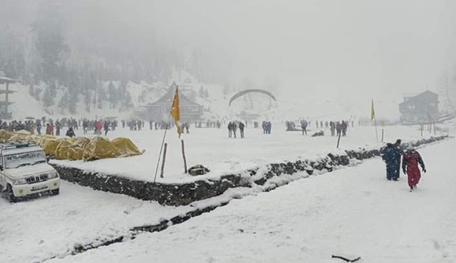 White mantle: Tourists enjoy snowfall at Solang Valley in Manali on Tuesday
