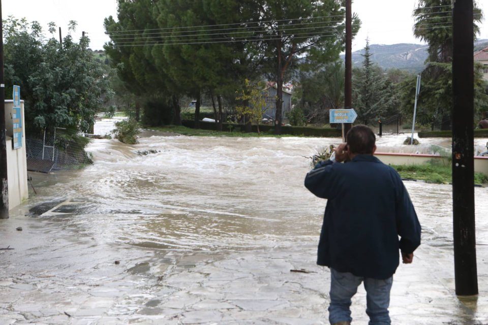 Click to enlarge The main road in Kalavassos where water from the overflowing reservoir is following the original course of the river from before the dam was built