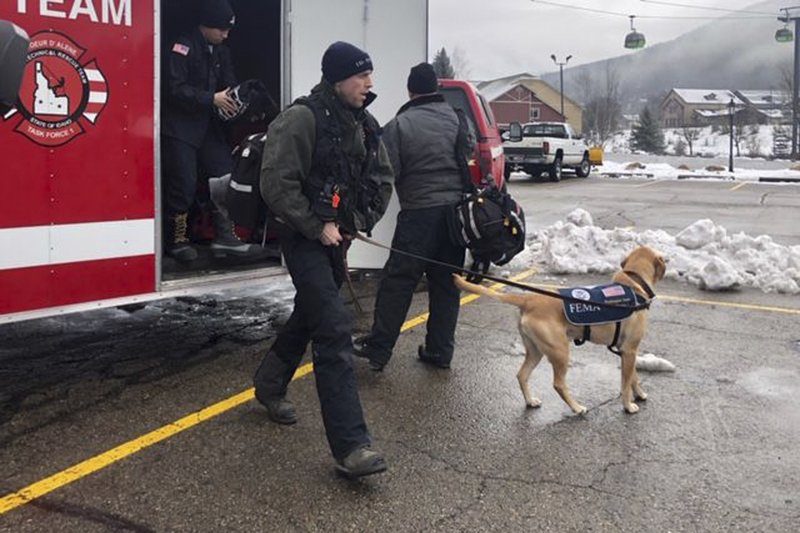 In this Tuesday, Jan. 7, 2020, photo provided by KHQ, the Coeur d'Alene Fire Department K-9 Team responds to Silver Mountain for an avalanche in Kellogg, Idaho.