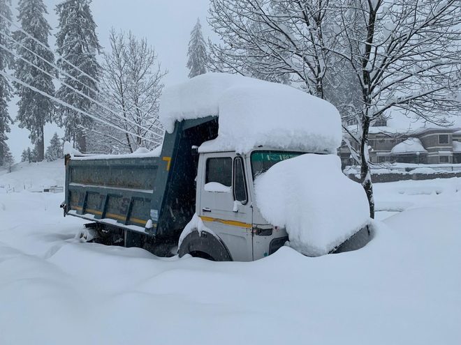 A snow-covered truck trapped in the Solang valley.