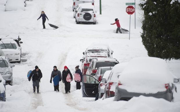 People use the street to slide down following a major snow storm in Burnaby, B.C., on Jan. 15, 2020. Vancouver and the lower mainland have been pounded with heavy snow fall and freezing temperatures