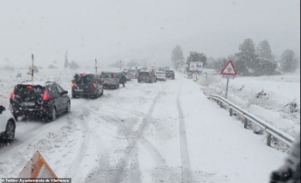Snow plough moves down a blocked main road in Vilafranca, about 40 miles from the Valencian coastline. A 54-year-old woman has died, local media reports, and a 44-year-old man was killed yesterday by a van that had lost contro