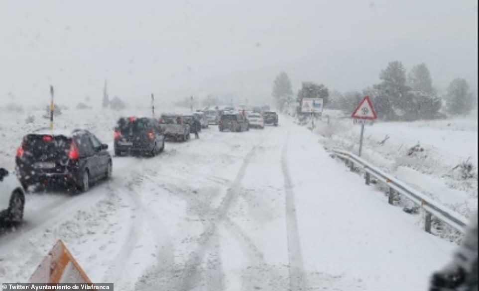 Click to enlarge Snow plough moves down a blocked main road in Vilafranca, about 40 miles from the Valencian coastline. A 54-year-old woman has died, local media reports, and a 44-year-old man was killed yesterday by a van that had lost contro