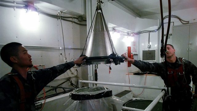 Soldiers mount a refurbished nuclear warhead