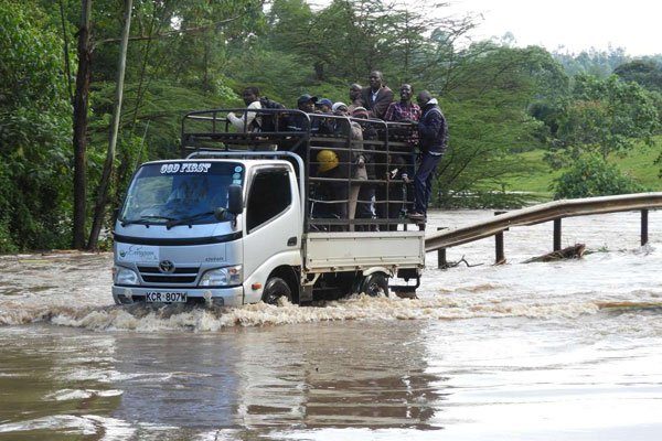 A motorist drives on a flooded Mugeni bridge in Sotik, Bomet County, on January, 31, 2020.