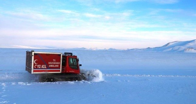 Click to enlarge A snow ambulance carrying a pregnant woman to a hospital travels on a village road in Turkey