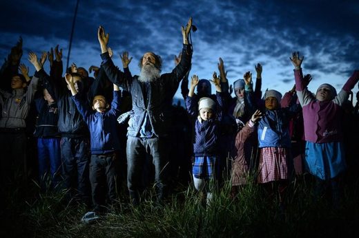 Click to enlarge Poteryaevka village, Altai Oblast. Evening prayer in the Orthodox community.