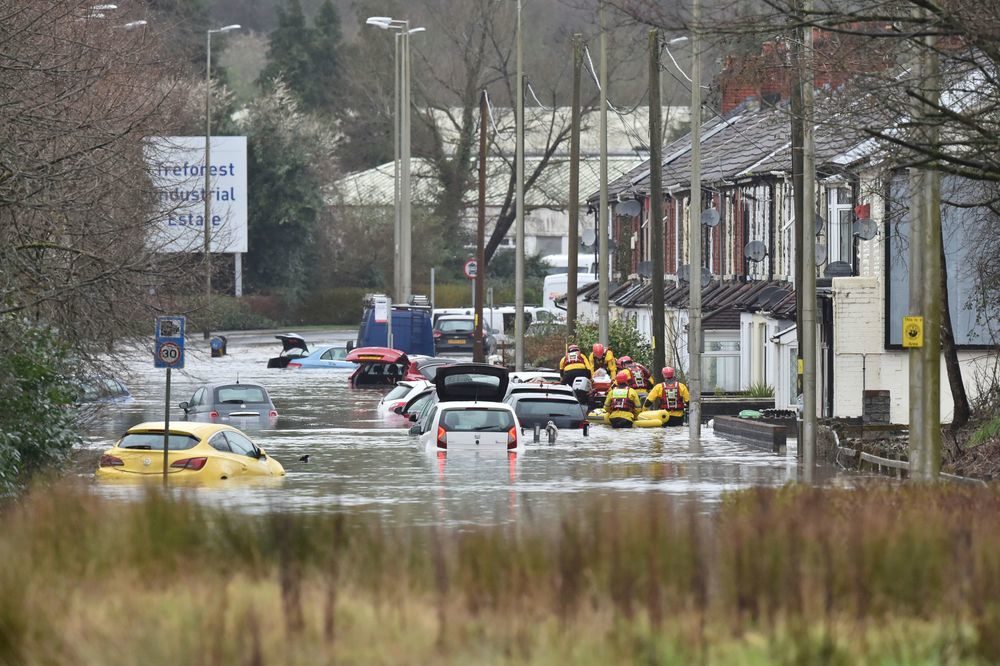 Click to enlarge A member of the public is rescued after flooding in Nantgarw, Wales, Sunday, Feb. 16, 2020.