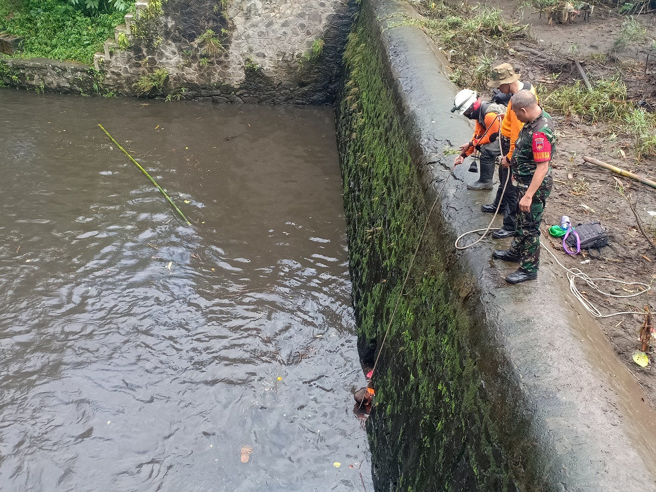 Rescue personnel look for missing scouts at a weir in Sembor River, Donokerto village, Sleman, Yogyakarta, on Feb. 22.