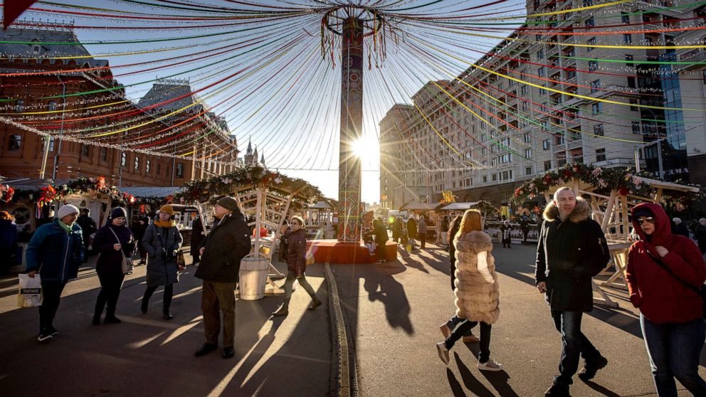 Click to enlarge Tourists walk at a holiday market