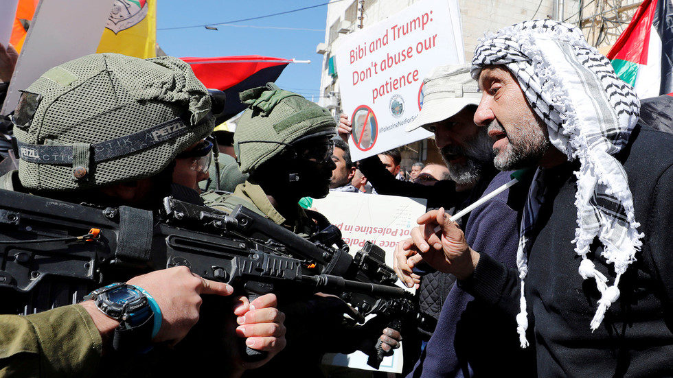 Click to enlarge Palestinians argue with Israeli forces during a protest in Hebron