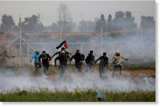 Click to enlarge Palestinian demonstrators run away from Israeli fire and tear gas