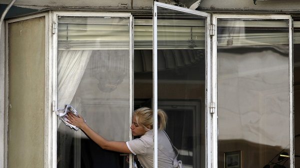 Maid cleans windows