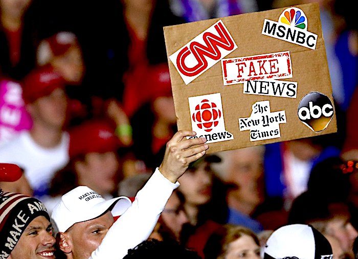 crowd/fake news sign