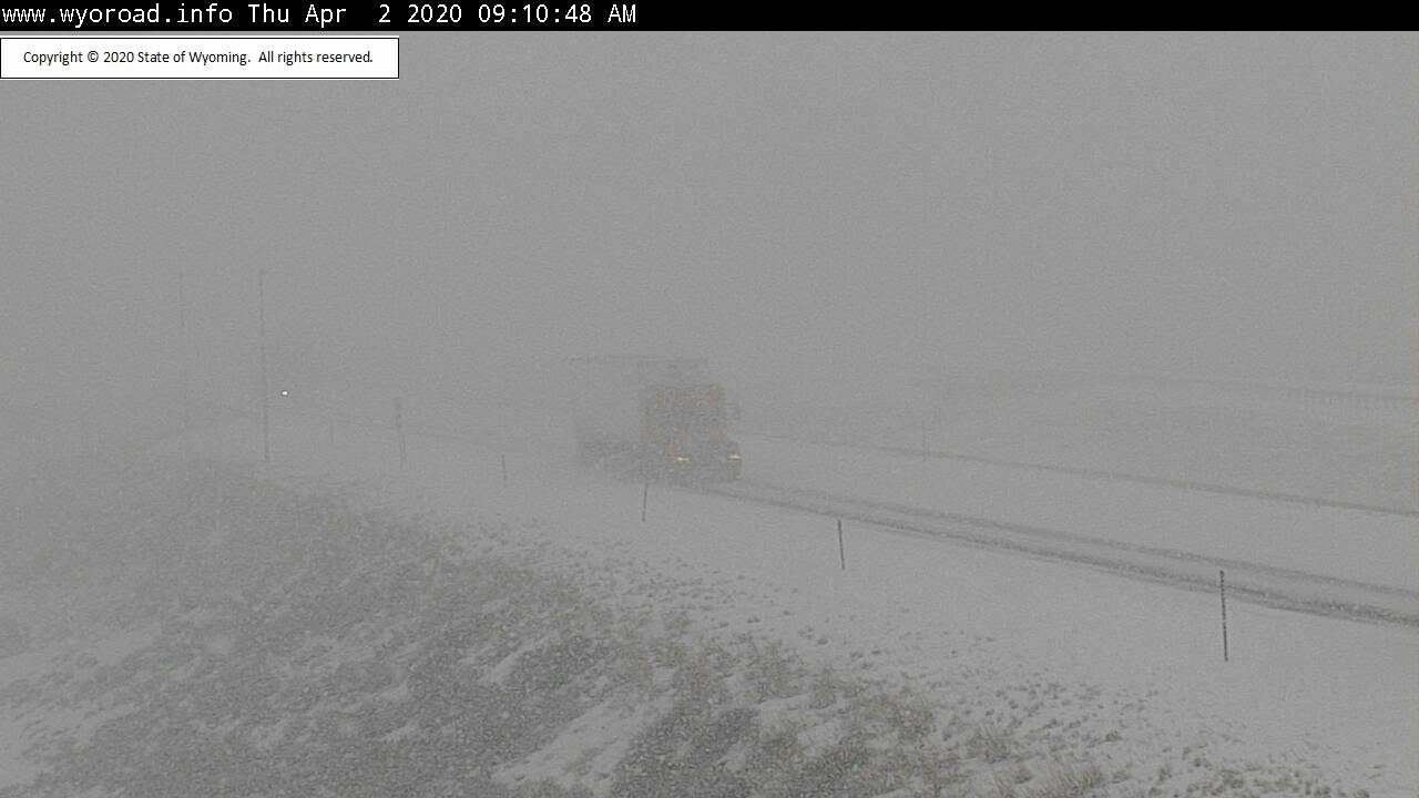 Near-whiteout conditions along Interstate 80 caused slower travel west of Laramie, Wyoming, as a band of snow moved through the area.