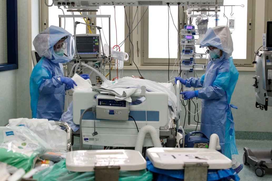 Click to enlarge Health care professionals in protective suits