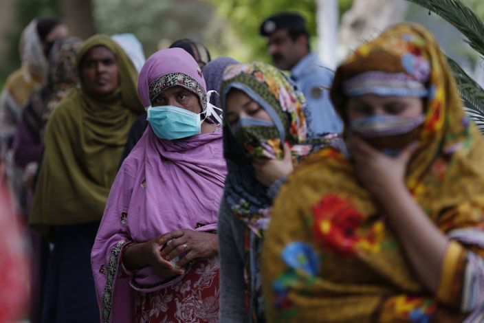 Click to enlarge Woman in Islamabad in line