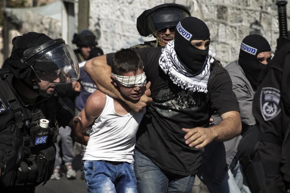 Click to enlarge File photo of a Palestinian child being arrested in Jerusalem