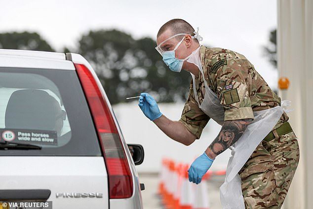 Click to enlarge Soldier swabbing driver for COVID in Plymouth