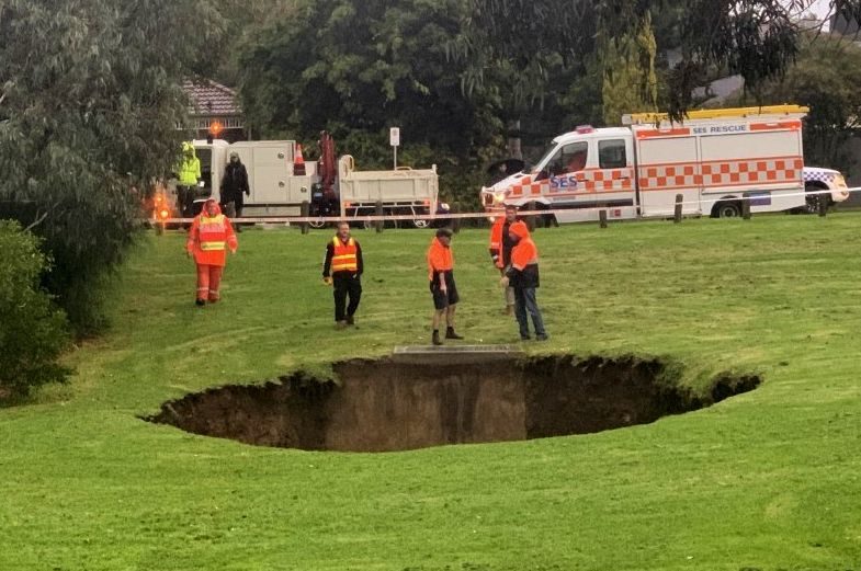 Click to enlarge Police and SES were on the scene to keep people away from the sinkhole.