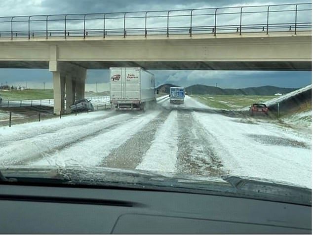 Snow covered a road in South Dakota on Sunday during a storm system that brought on large hailstones