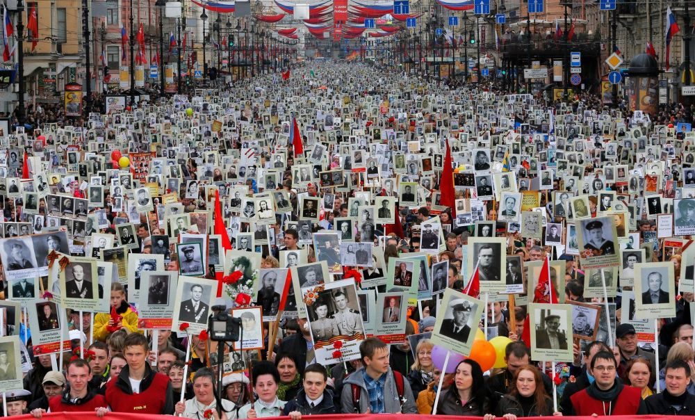 Click to enlarge Residents of St. Petersburg carry portraits of their ancestors on Victory Day