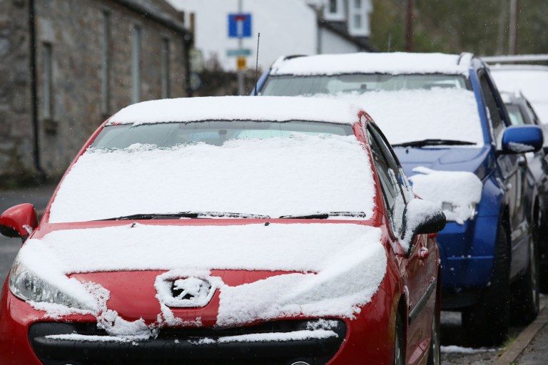 Snow covered cars in the village of Tomintoul