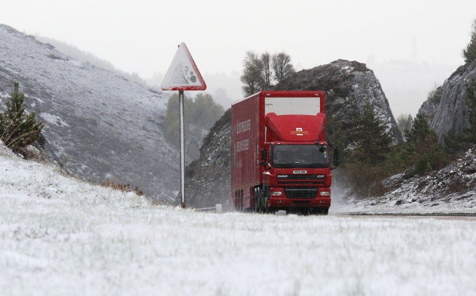 A Royal Mail delivery lorry on the A9 near Inverness where fresh snow has fallen today