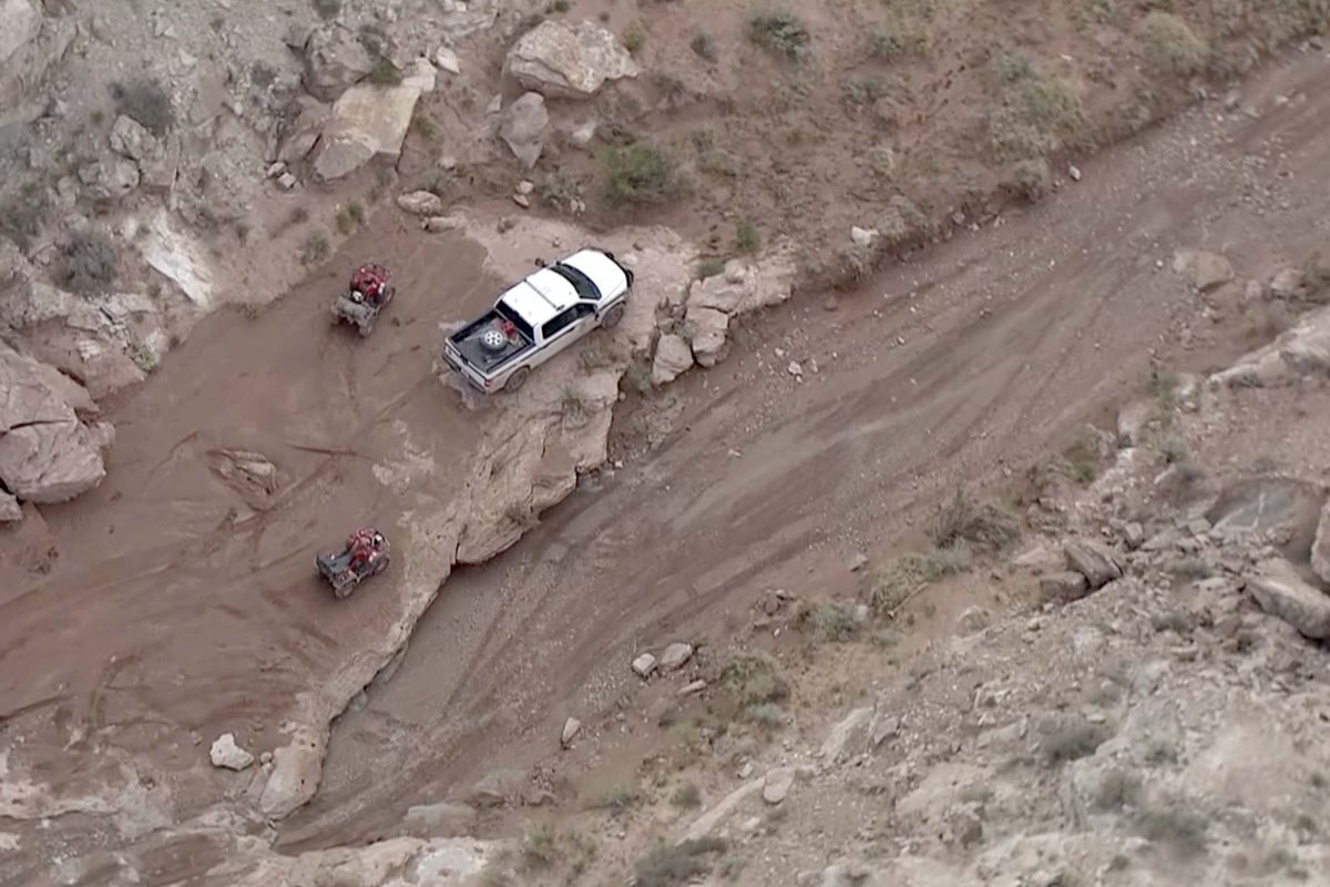 Click to enlarge Search teams work in the area where heavy rains