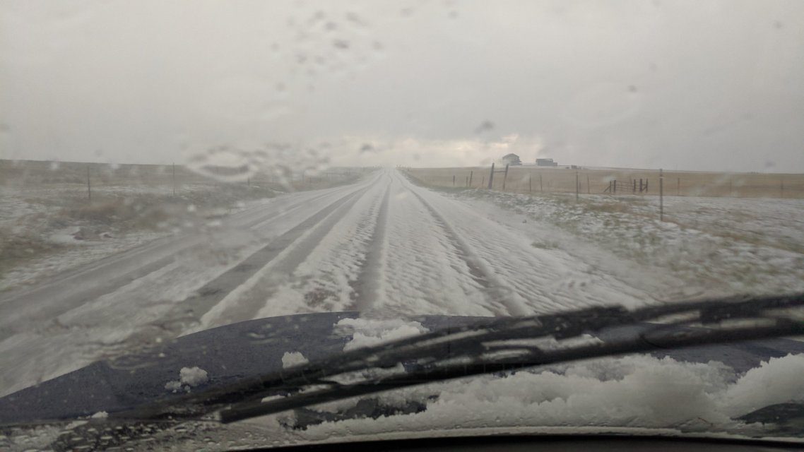 Click to enlarge Hail covered the ground as a severe